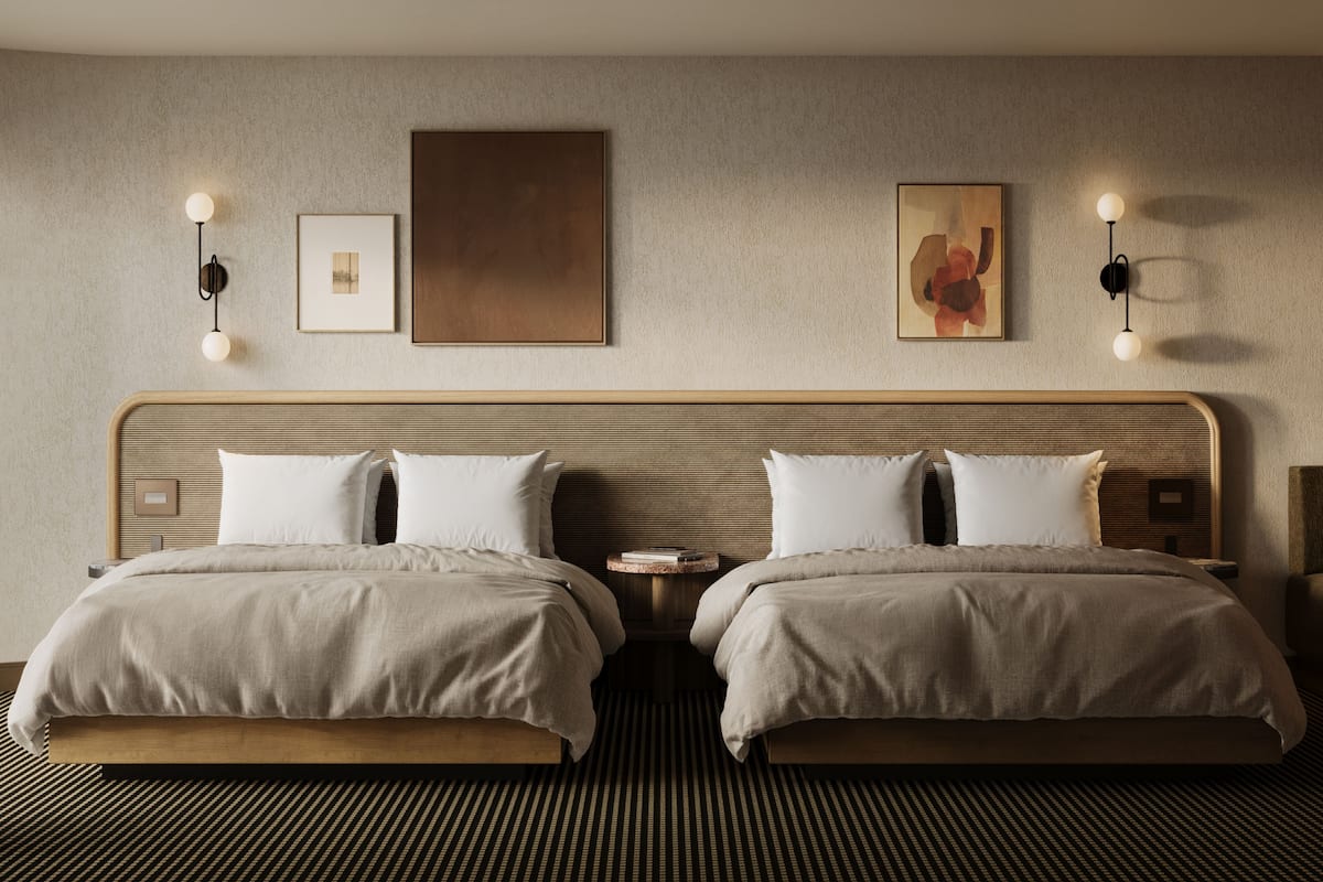 A modern hotel room with two beds, a large artwork on the wall, and wall-mounted lighting.