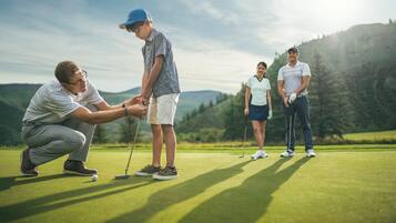 Golfers enjoy a round on the well-manicured course with scenic views of rolling hills.