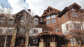 A large, multi-story wooden building with a prominent entrance and stone pillars. - Lodge at Brookside, A Vail Resorts Property (Avon)