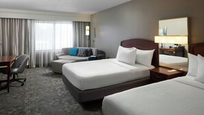 A hotel room with two beds, a desk, a chair, and a lamp. - Courtyard by Marriott Newark Granville (Newark)
