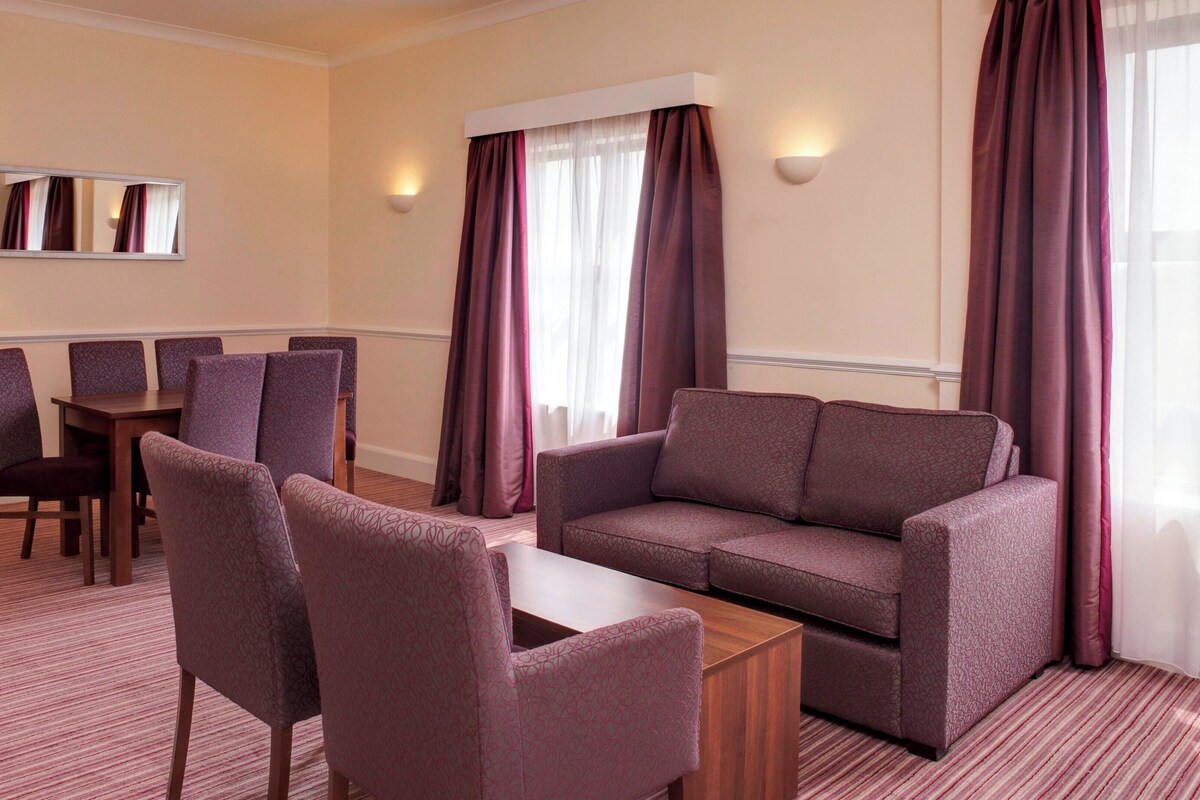 Suite, 1 Bedroom (Dining Area) | In-room safe, desk, laptop workspace, iron/ironing board