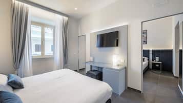 Deluxe Quadruple Room | Minibar, in-room safe, desk, blackout drapes