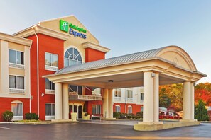 A Holiday Inn Express building with a covered entrance and a brick facade.