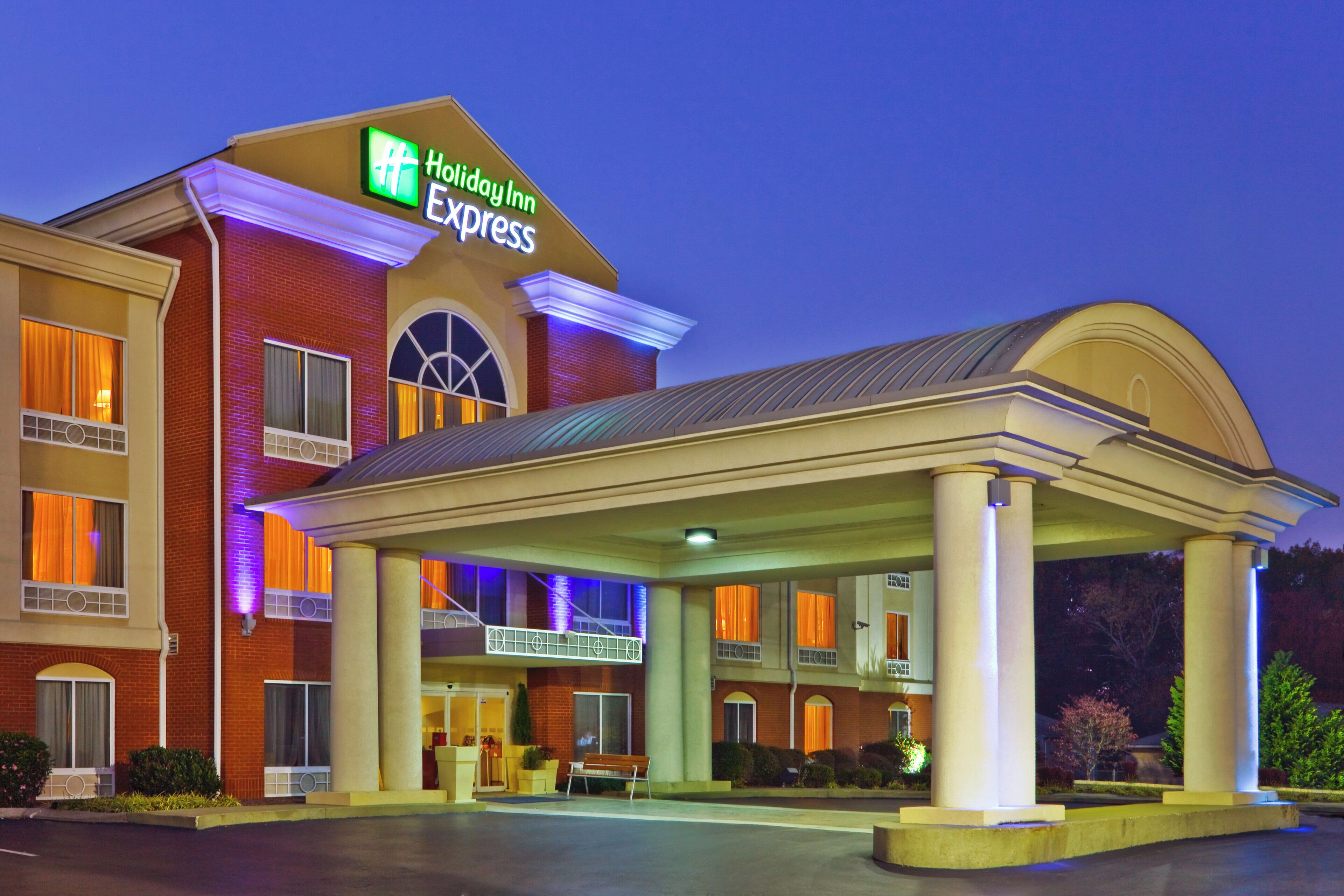 A Holiday Inn Express hotel with a covered outdoor area and a brick facade.