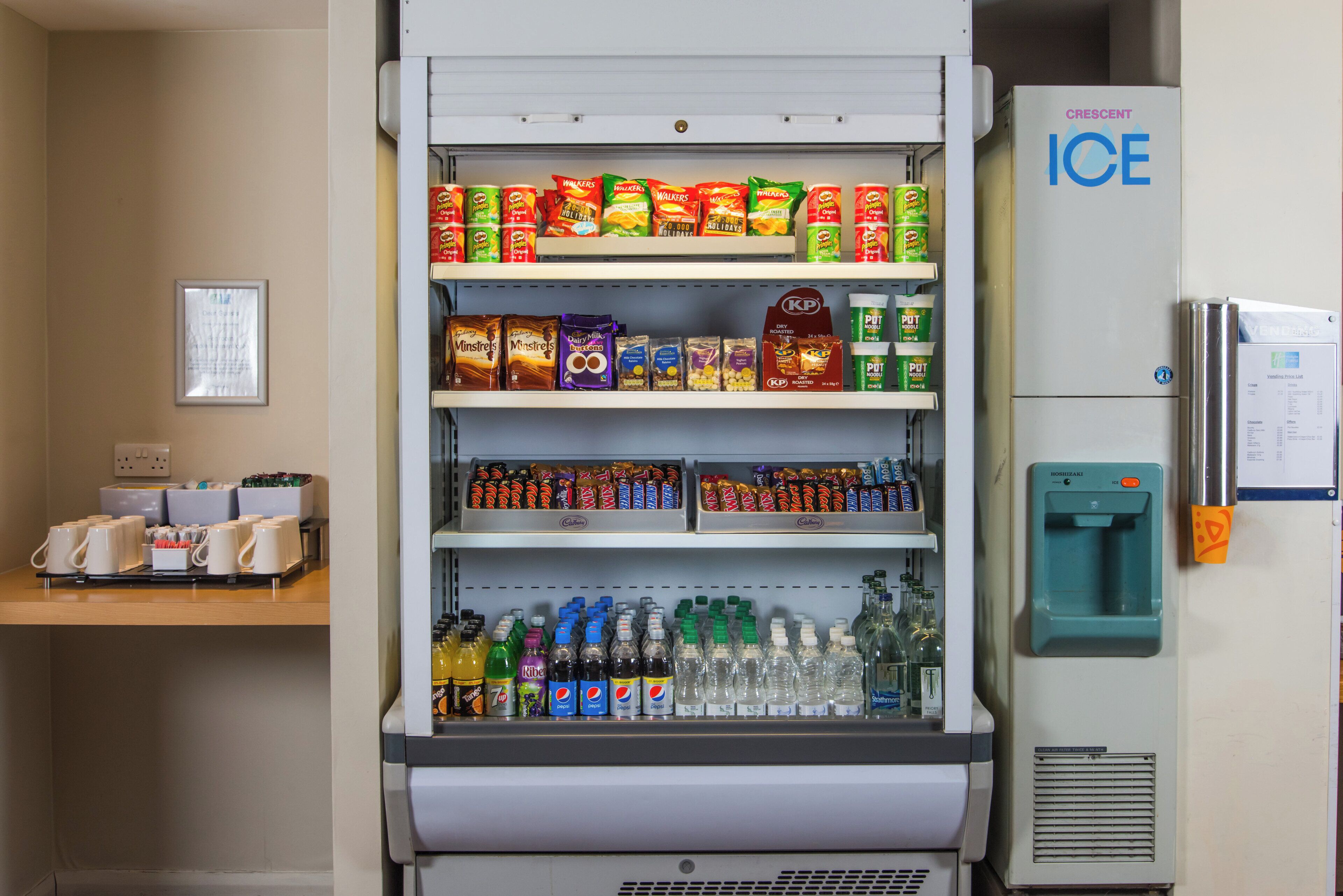 A vending machine with a variety of snacks, beverages, and a water dispenser.