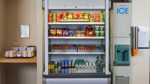 A vending machine with a variety of snacks, beverages, and a water dispenser.