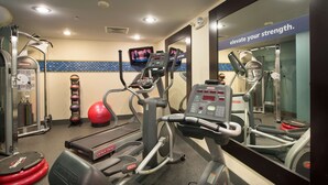 A gym with cardio machines, free weights, and a mirrored wall. - Hampton Inn Cornelia (Cornelia)