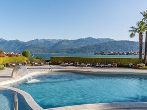 Seasonal outdoor pool, open 10:00 AM to 7:00 PM, pool umbrellas