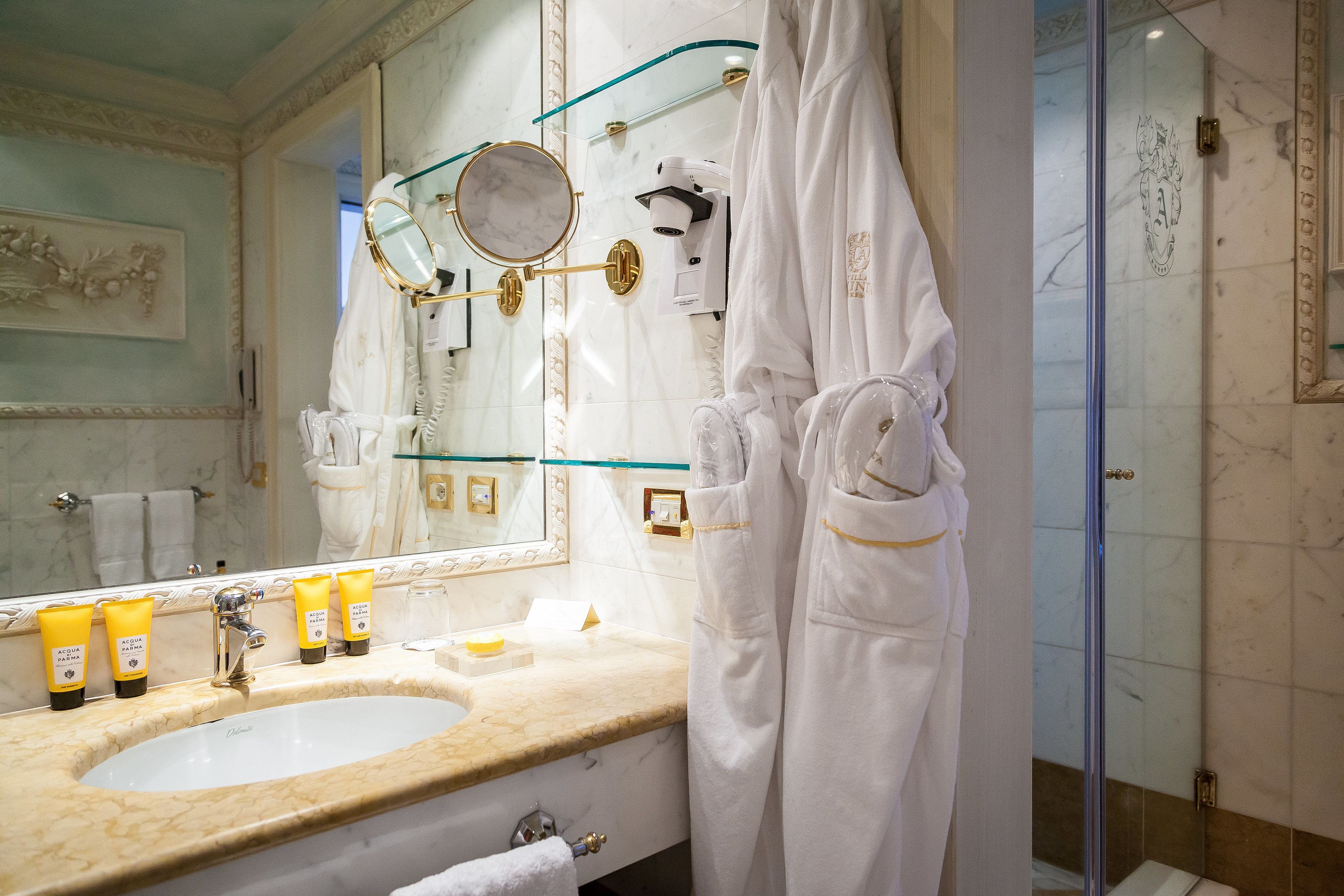 designer toiletries, hair dryer, bathrobes, slippers