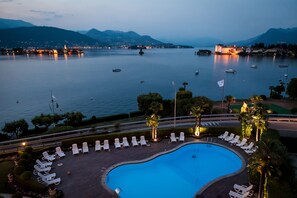 Seasonal outdoor pool, open 10:00 AM to 7:00 PM, pool umbrellas