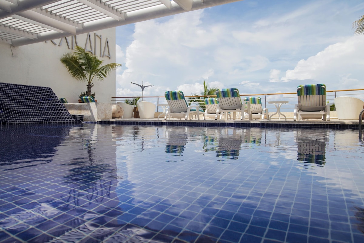 A crystal clear blue tiled pool at Casa Mexicana Dive Hotel Cozumel.
