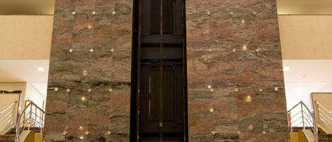 A tall, marble column with a sign reading "Bristol International Airport" and "Dably" at the base.