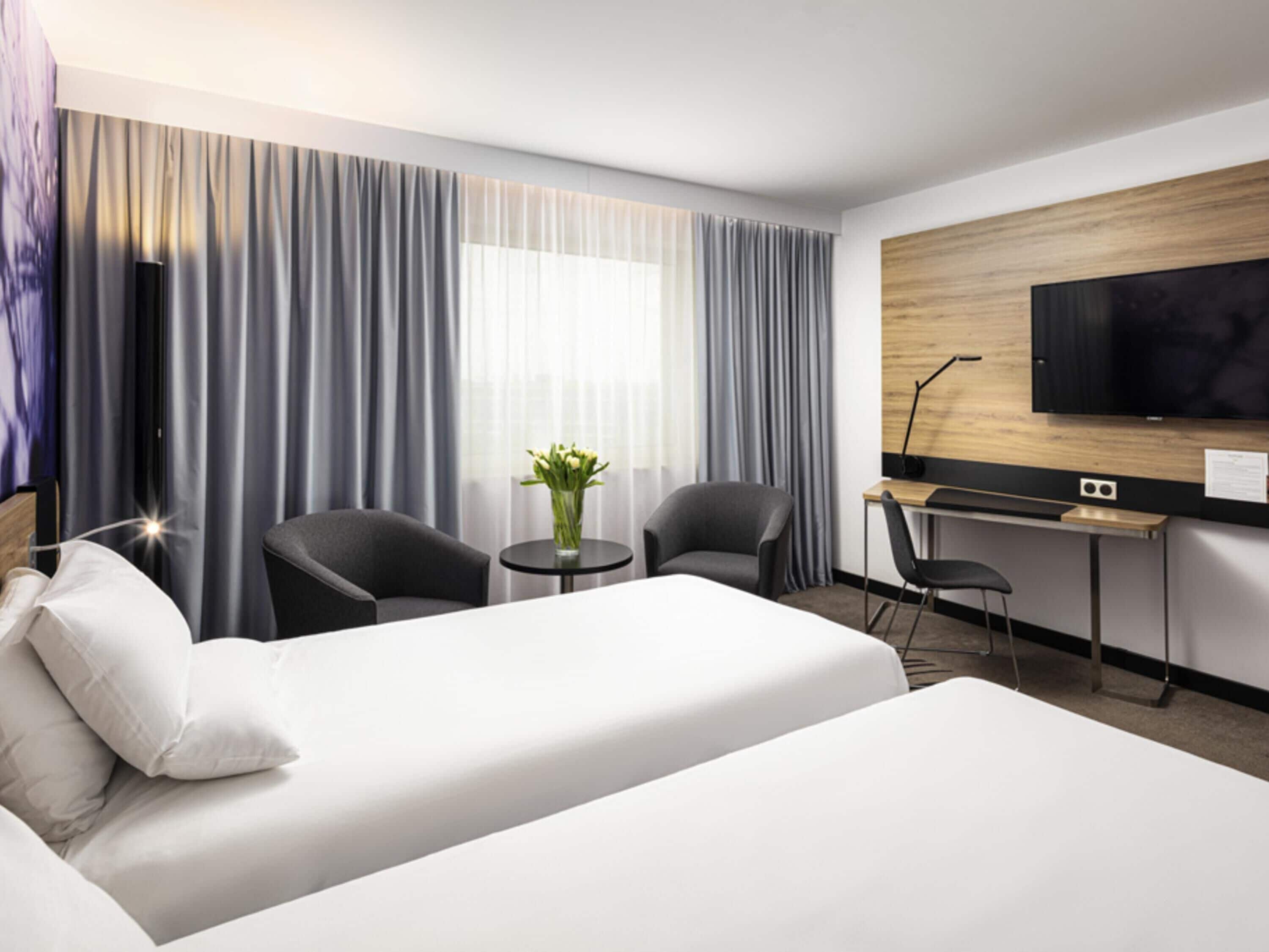 Hypo-allergenic bedding, desk, laptop workspace, blackout curtains