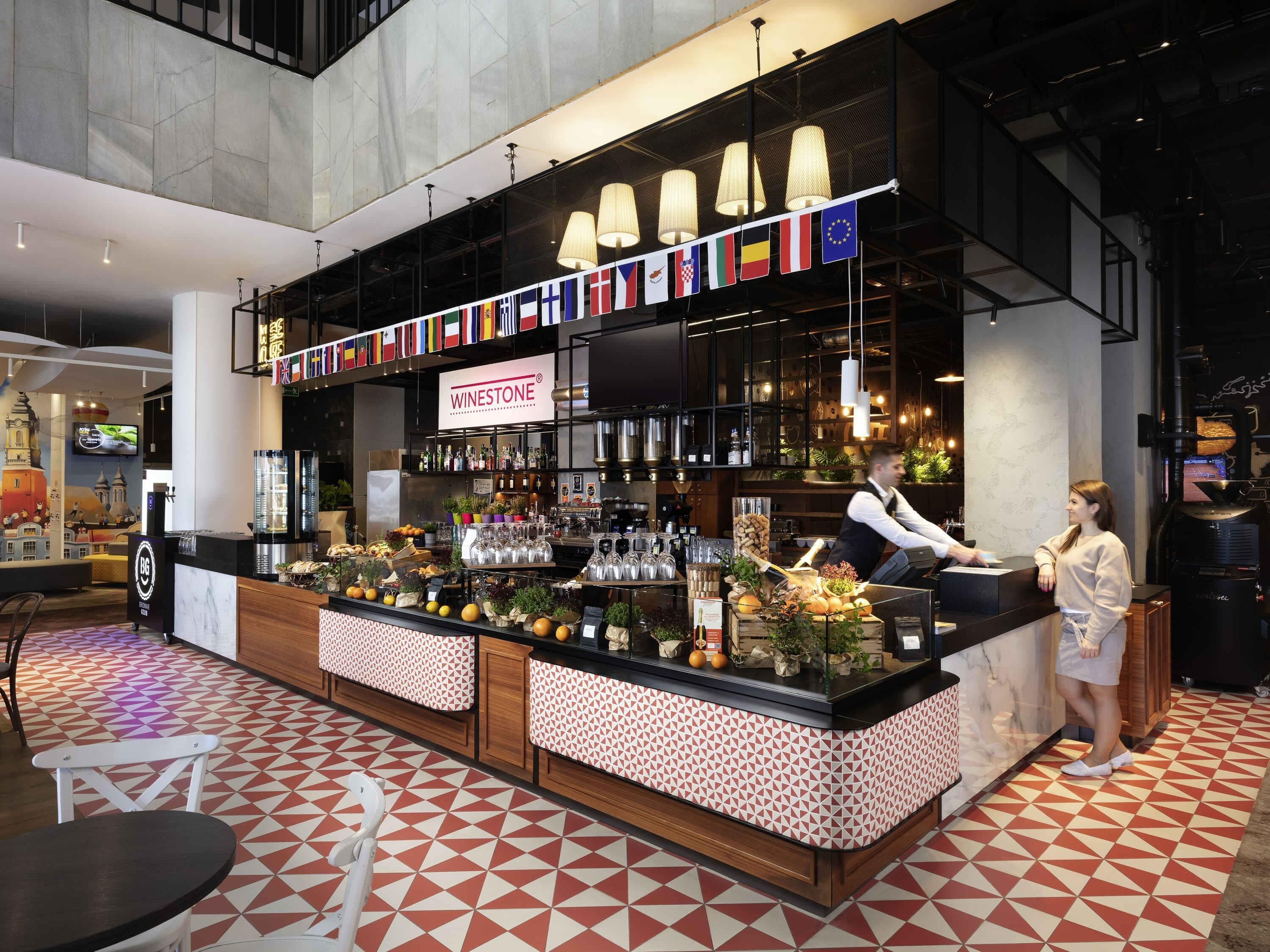 A bar area with a wine selection, a counter, and a patterned floor.