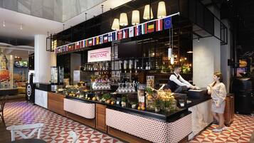 A bar area with a wine selection, a counter, and a patterned floor.