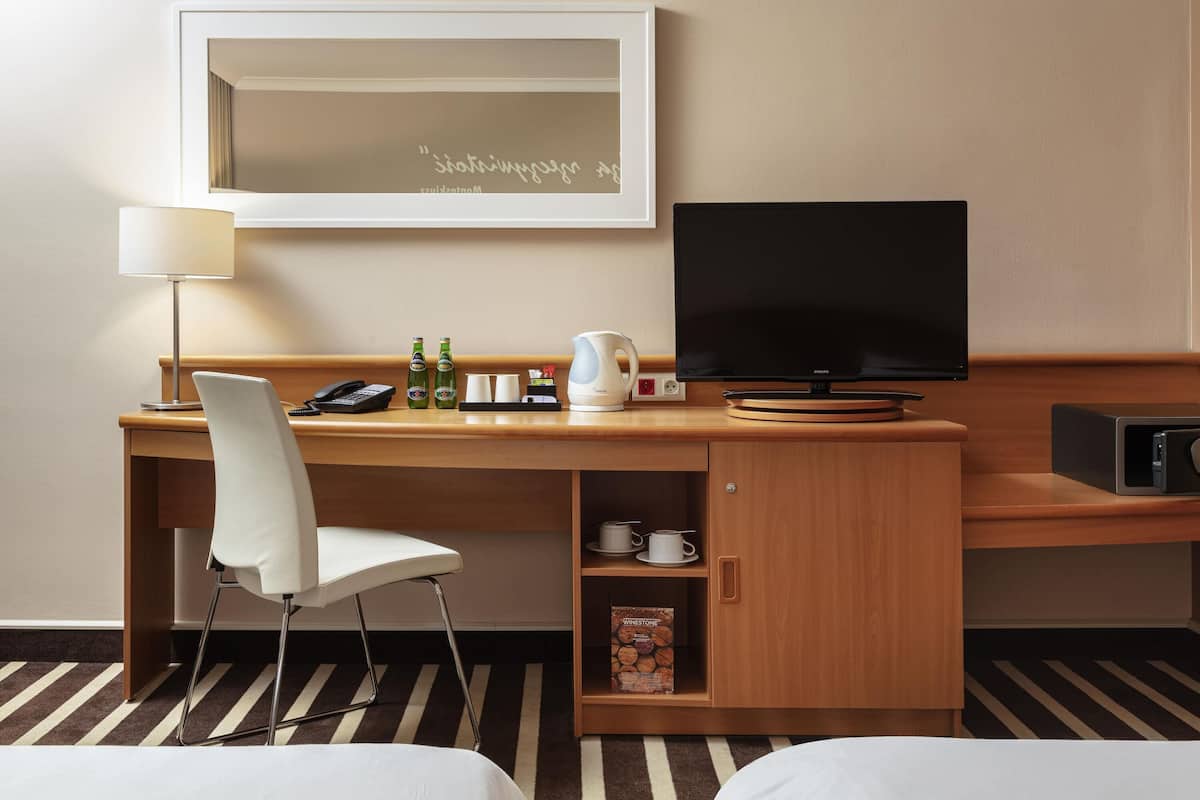 Hypo-allergenic bedding, desk, laptop workspace, blackout curtains