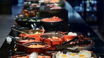 A buffet with various dishes and condiments.