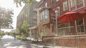 A red-brick building with a sign for 'The Conwell Inn' and a red umbrella. - The Conwell Inn (Philadelphia)
