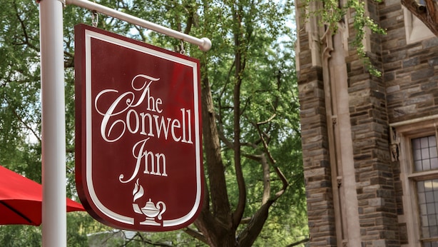 A sign for The Conwell Inn, featuring a classic design with a cup and saucer emblem. - The Conwell Inn (Philadelphia)