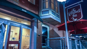 The Conwell Inn with a brick facade, a large entrance door, and a sign above the door. - The Conwell Inn (Philadelphia)