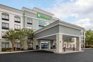 A Holiday Inn hotel with a modern facade, large windows, and a covered entrance area. - Holiday Inn Cleveland by IHG (Cleveland)