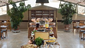 A buffet setup with various food items and serving utensils on a table under a large tent. - Armada Istanbul Old City Hotel (Istanbul)