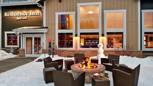 A Residence Inn Marriott with a fire pit and outdoor seating area.