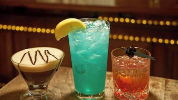 Three different drinks on a wooden table.