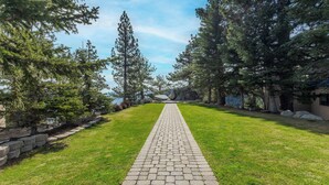 A paved pathway leading through a park with trees and a view of a body of water. - Holiday Inn Club Vacations Tahoe Ridge Resort by IHG (Stateline)