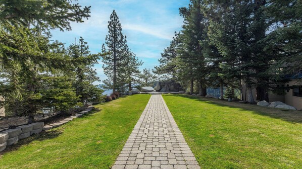 A paved pathway leading through a park with trees and a view of a body of water. - Holiday Inn Club Vacations Tahoe Ridge Resort by IHG (Stateline)