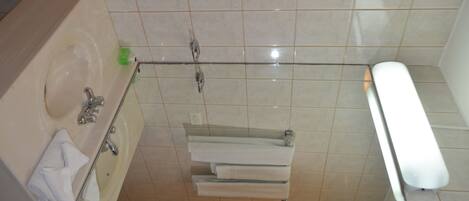 Un baño con lavamanos, espejo e inodoro.