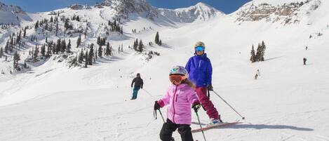 A snowy ski slope with skiers.