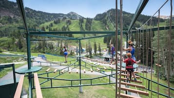 Explore the great outdoors from elevated platforms and cross suspension bridges amidst lush green hills.