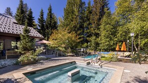 A swimming pool with steps, surrounded by trees and outdoor seating. - Horstman House by Whistler Premier (Whistler)