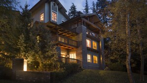A two-story house with a balcony and large windows, surrounded by trees. - Horstman House by Whistler Premier (Whistler)