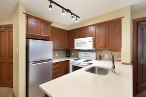 Three Bedroom Unit 206 | Private kitchen | Fridge, microwave, oven, stovetop