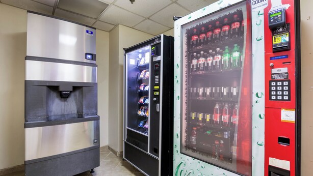 A row of vending machines with various beverages and snacks. - Red Roof Inn Carrollton (Carrollton)