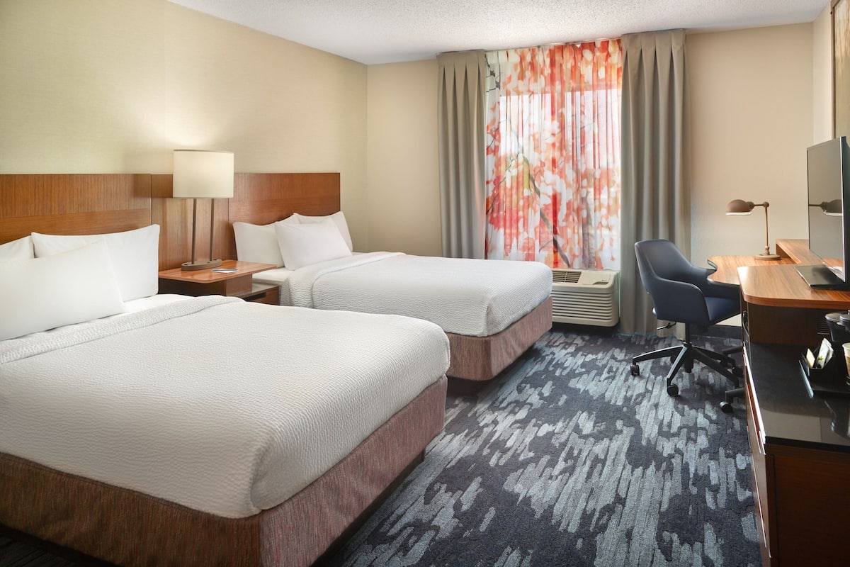 Premium bedding, desk, laptop workspace, blackout drapes