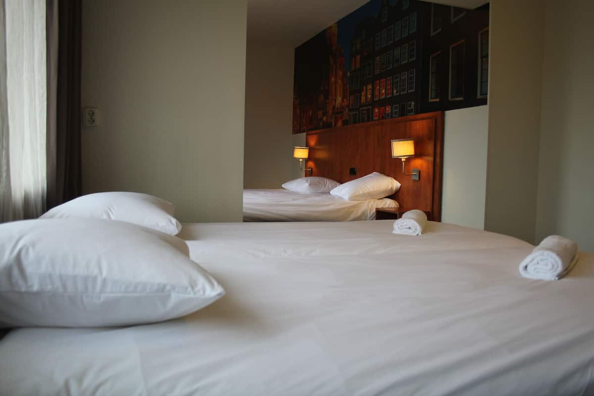 Ropa de cama hipoalergénica y caja de seguridad en la habitación