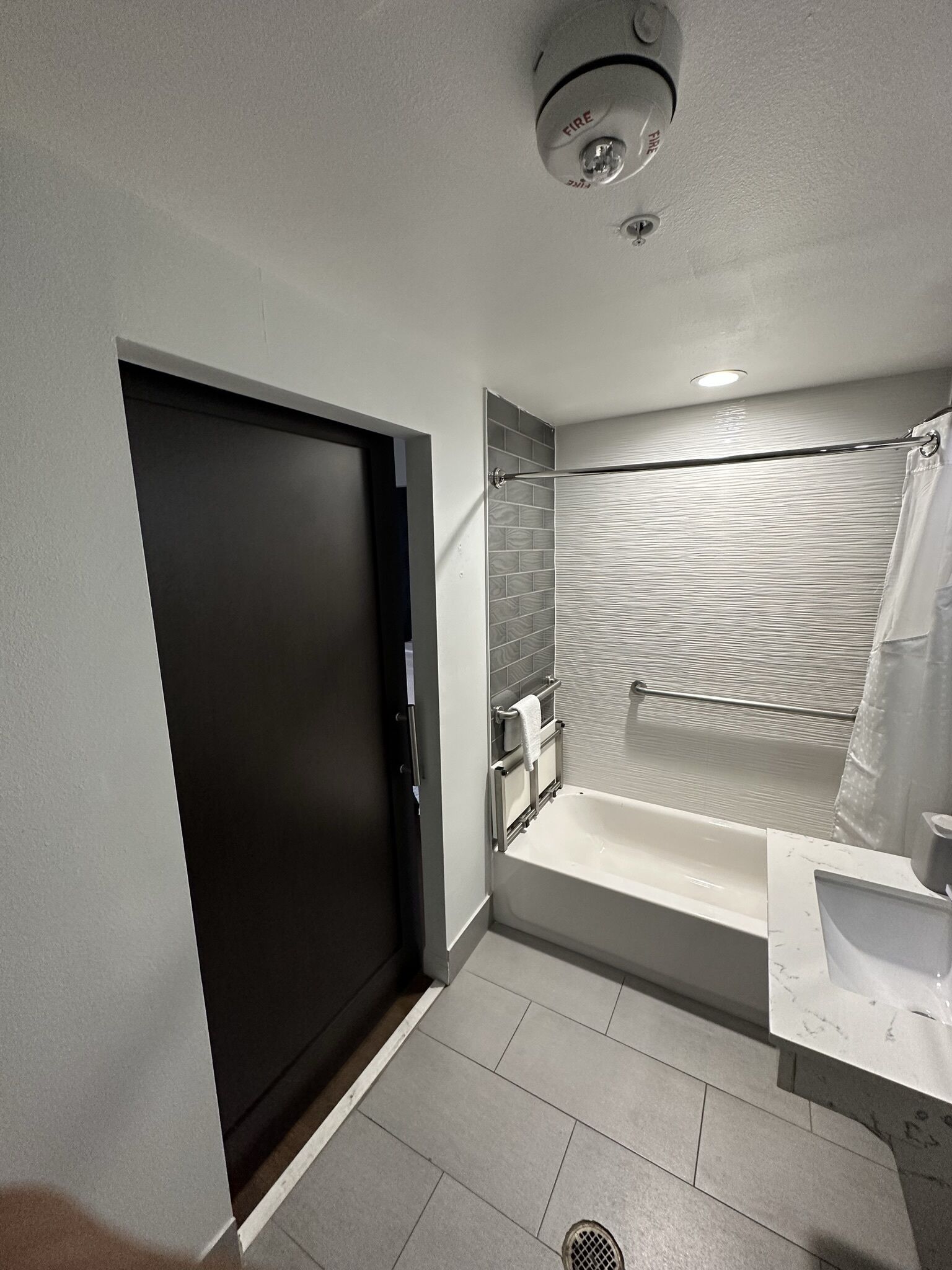 A modern bathroom with a bathtub, a shower, and a toilet.