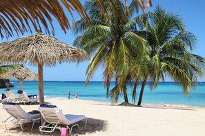 On the beach, sun-loungers, beach umbrellas, beach towels
