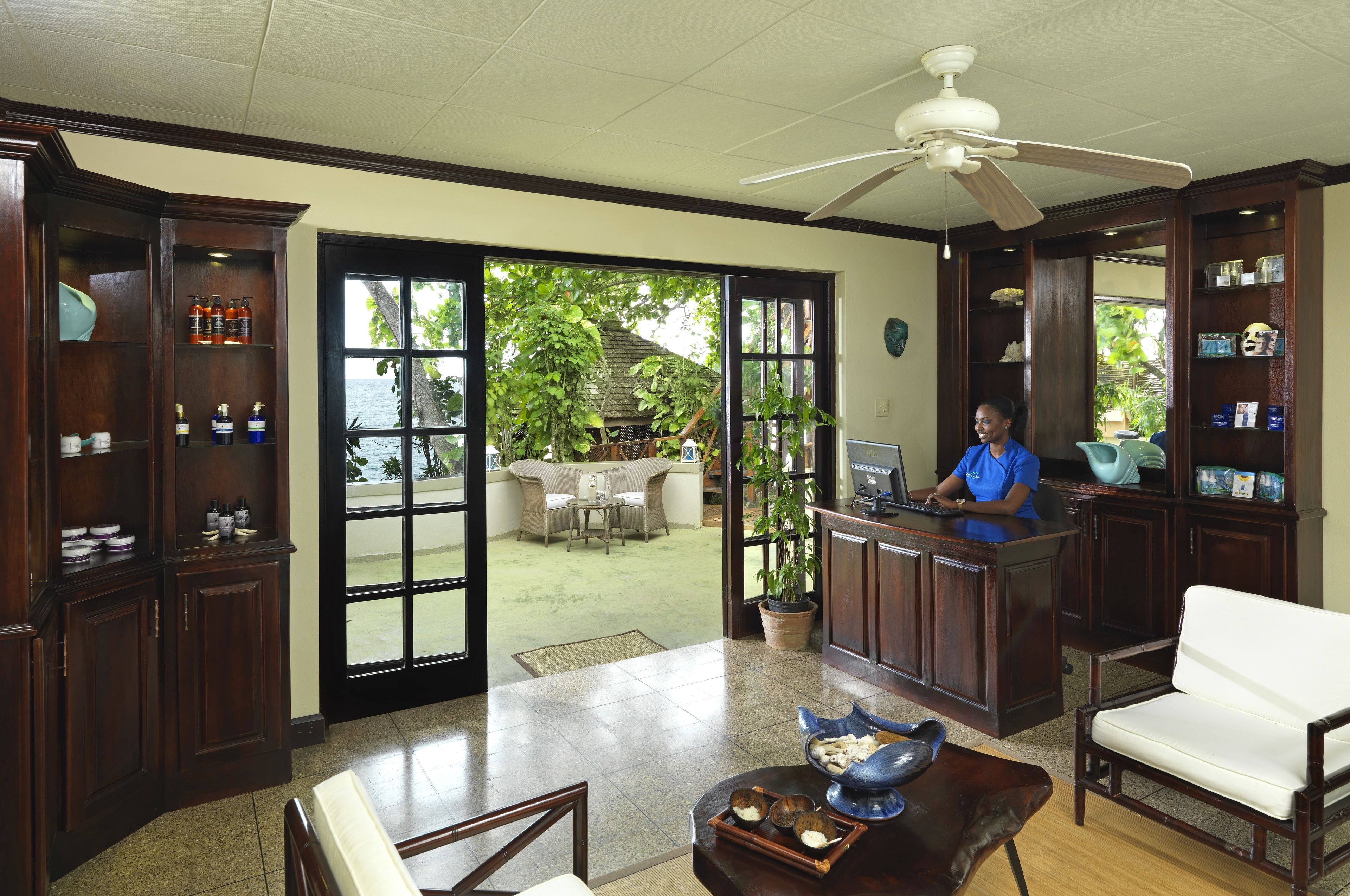 A reception area with a desk, chairs, and a large window offering a view of the outdoors.