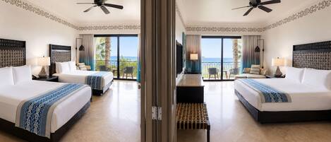 A hotel room with two beds, a balcony with a view, ceiling fans, and a minibar.