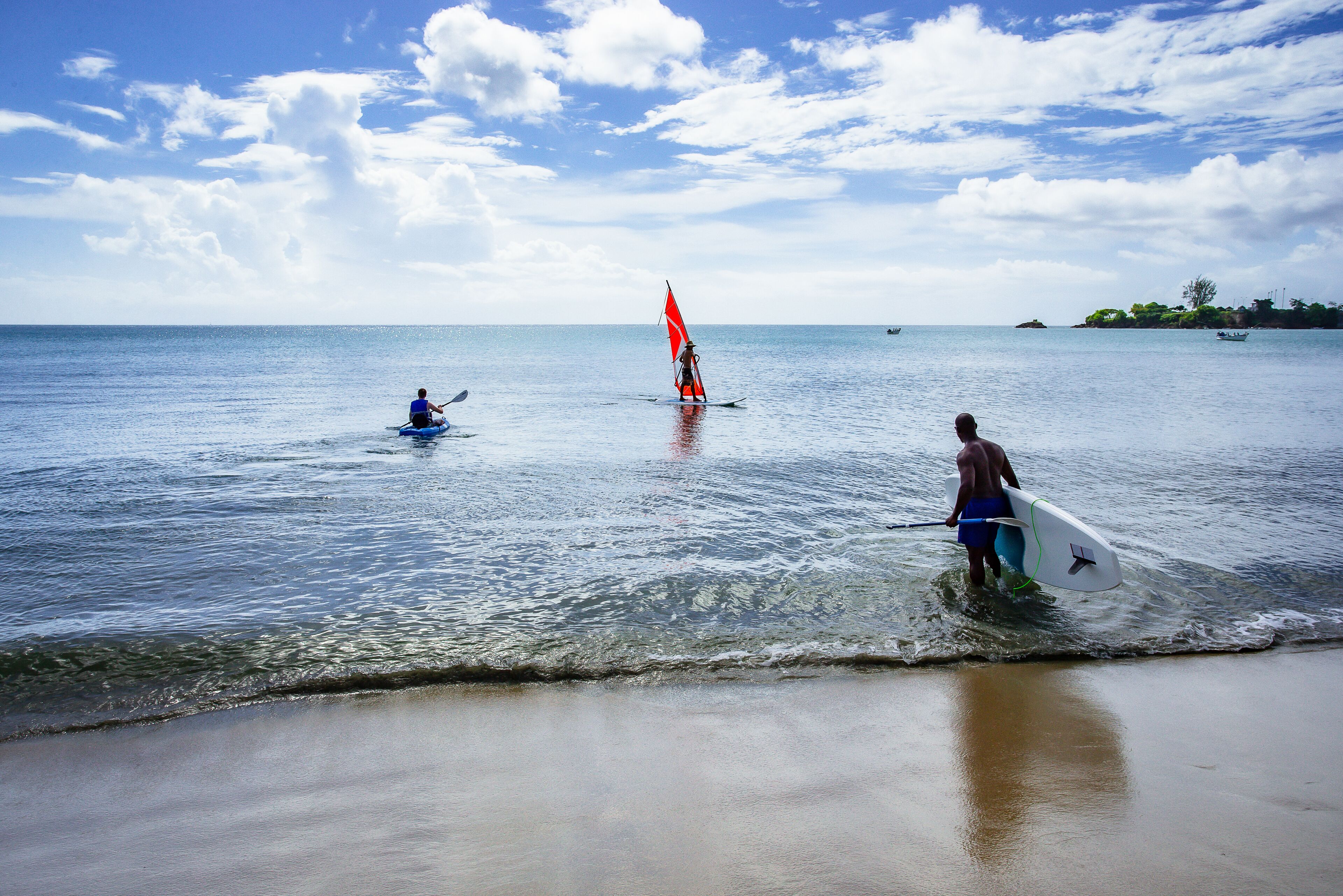 A beach scene with clear skies and calm waters.