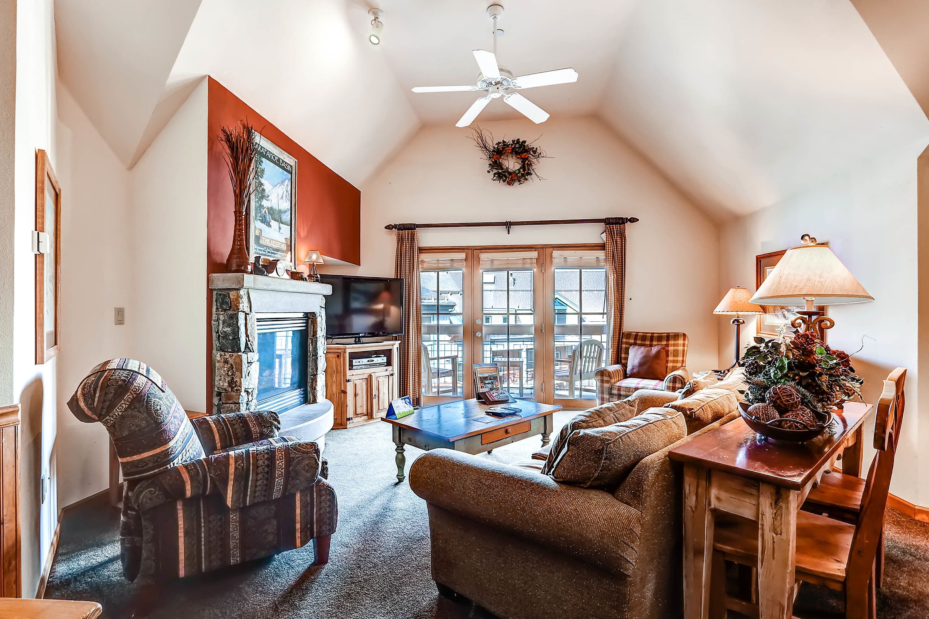 A cozy living room with a fireplace, comfortable seating, and a television.