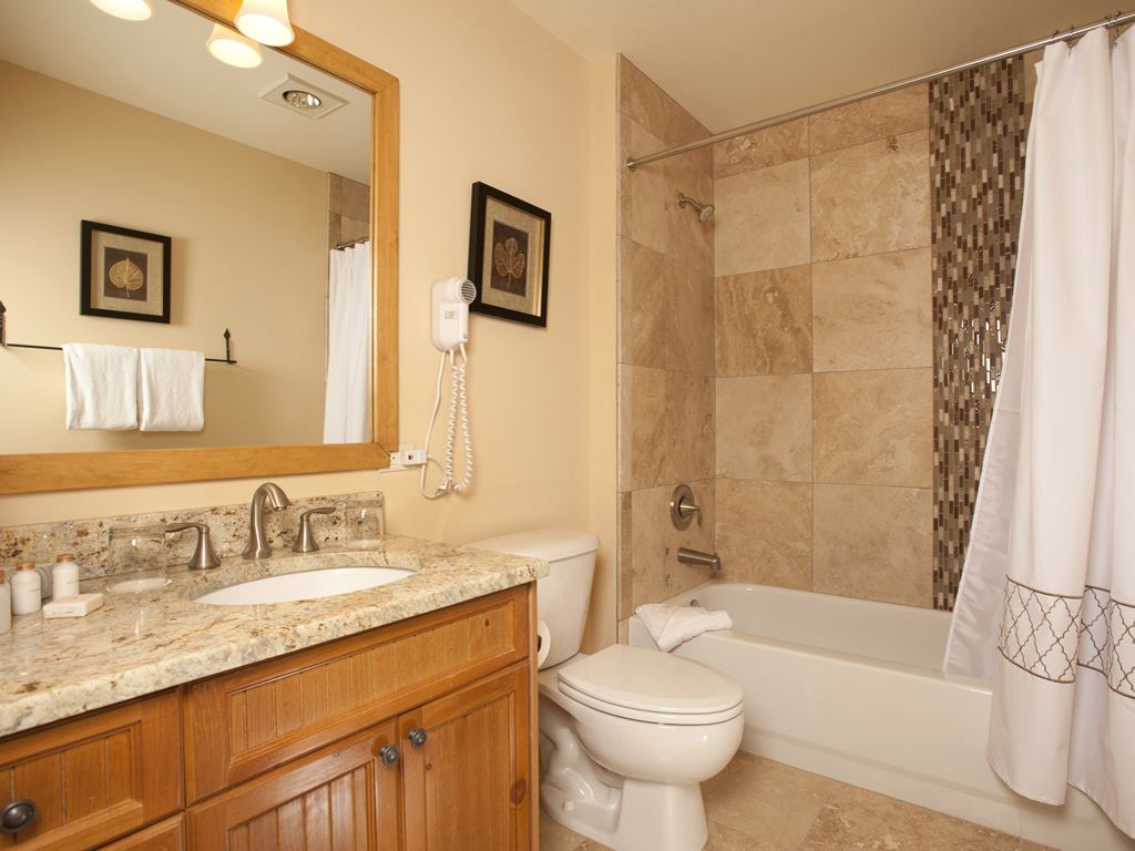 A bathroom with a sink, toilet, and bathtub.
