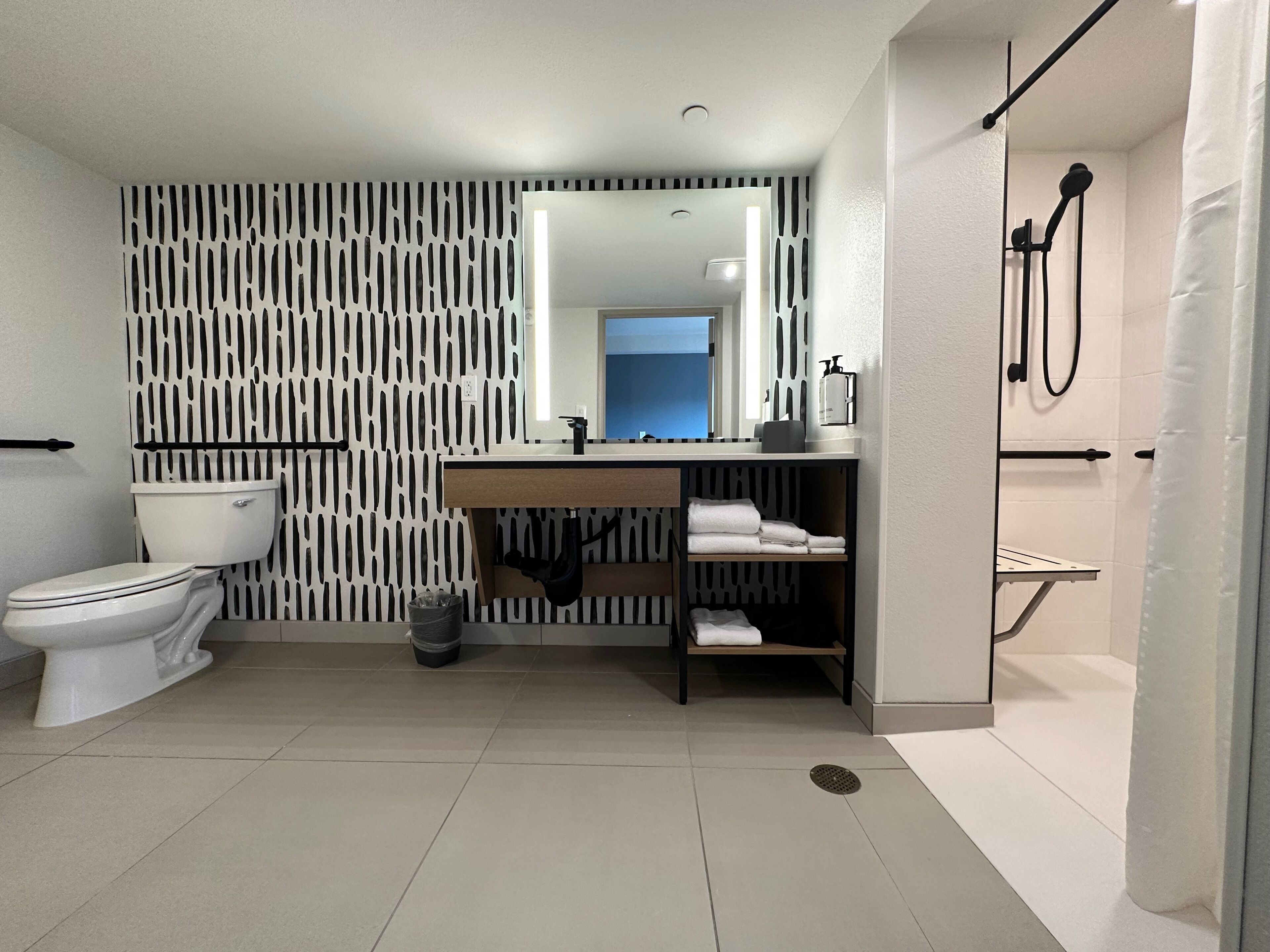 A modern bathroom with a toilet, sink, and shower area.