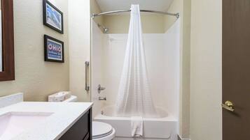 A bathroom with a bathtub, toilet, and sink.
