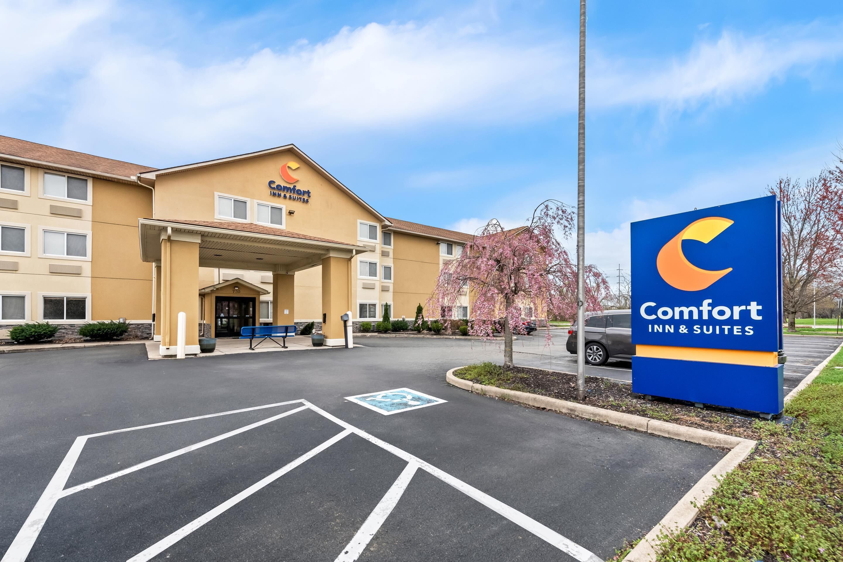 A Comfort Inn & Suites hotel with a parking lot, a covered entrance, and a signboard.