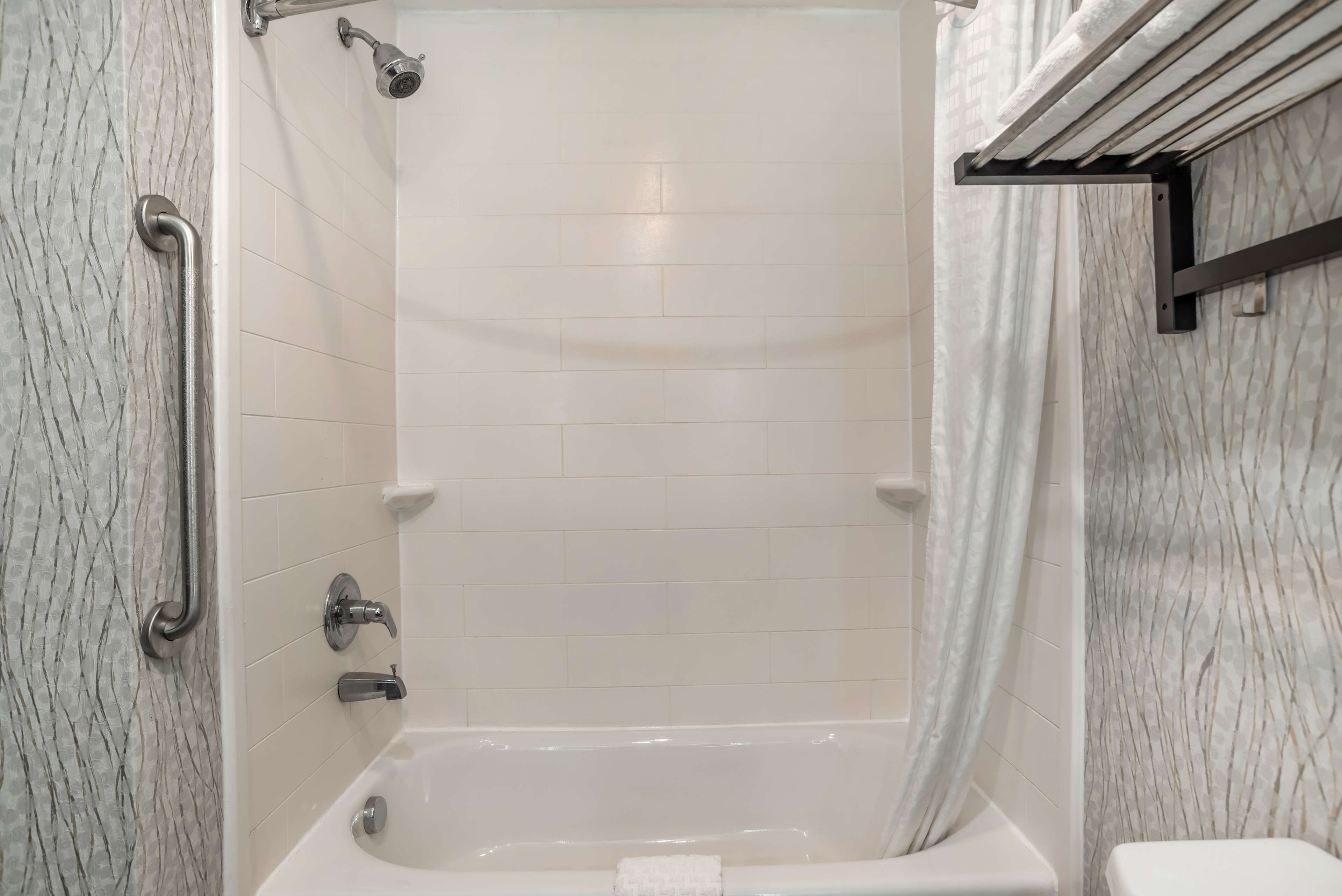 A bathroom with a bathtub, a shower, and a toilet.